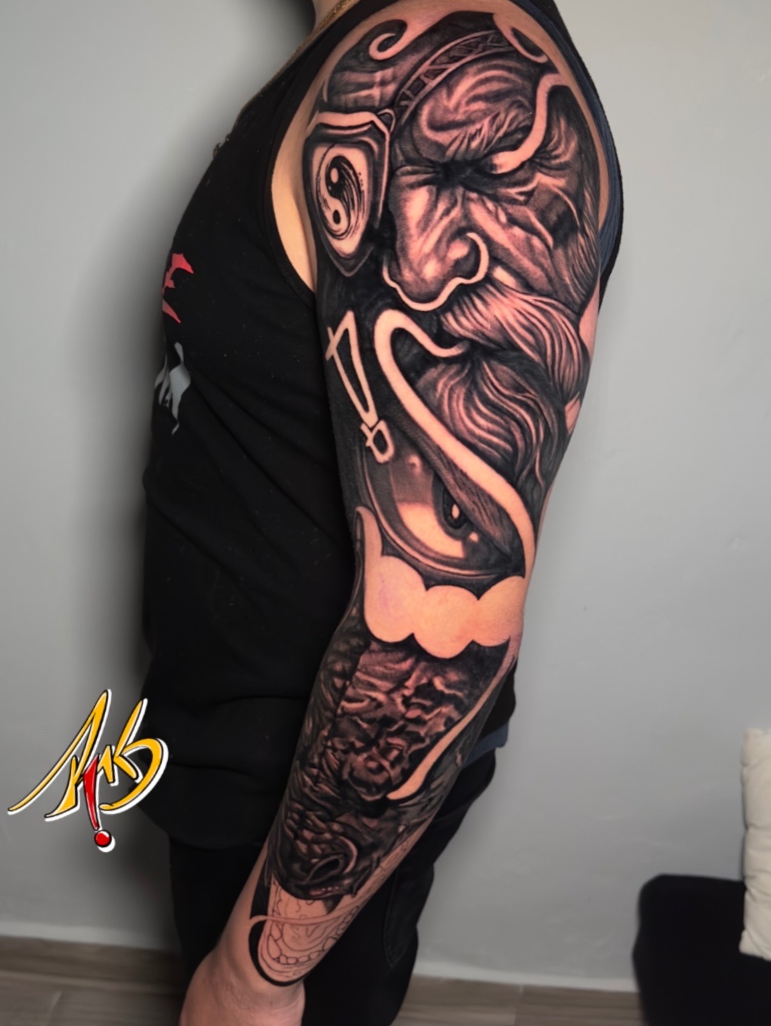 Large-scale black and grey warrior sleeve tattoo by Ramón Santiago at R INKS ARTS