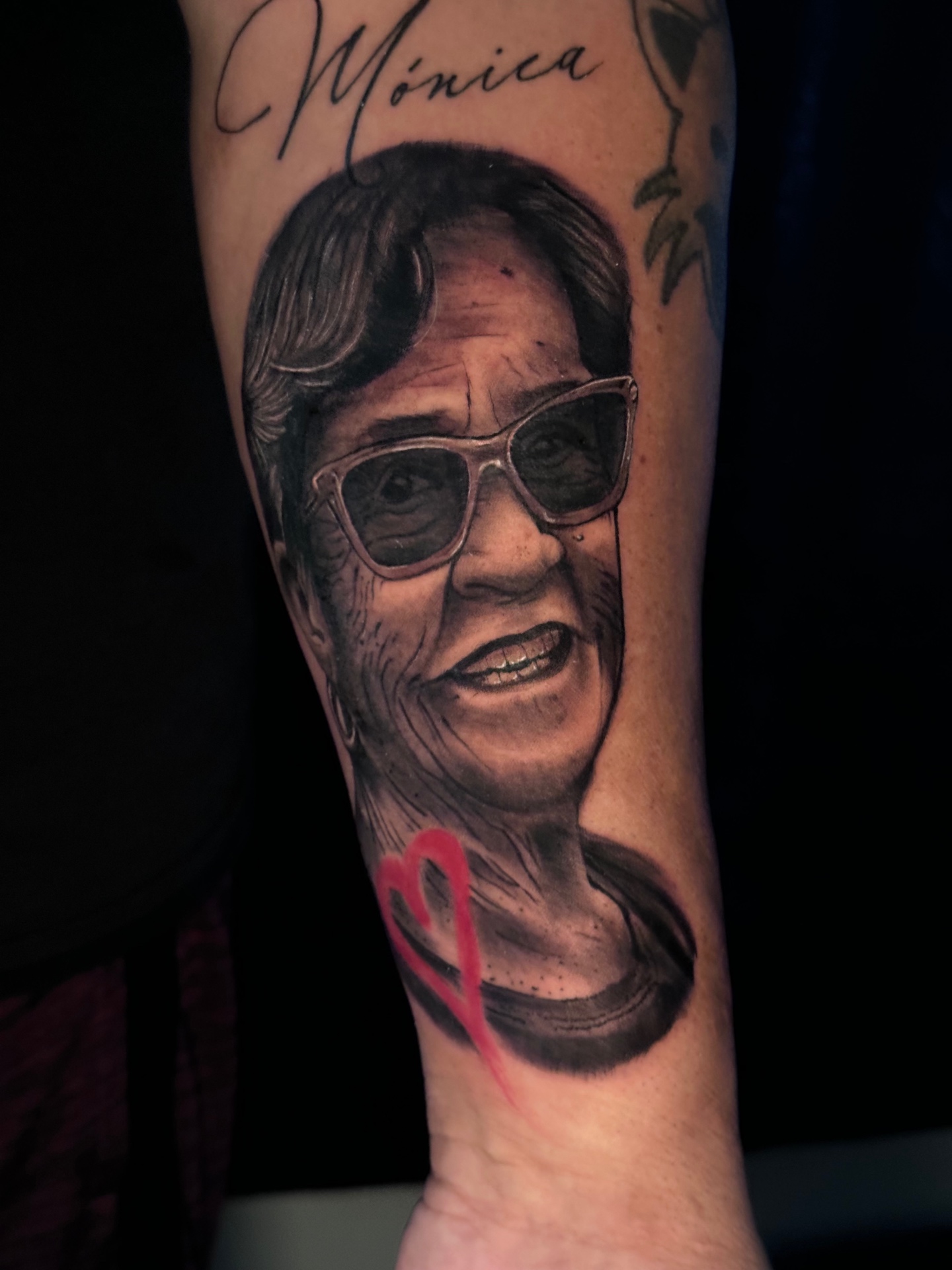 Black and grey memorial portrait tattoo with a red heart by Ramón Santiago at R INKS ARTS