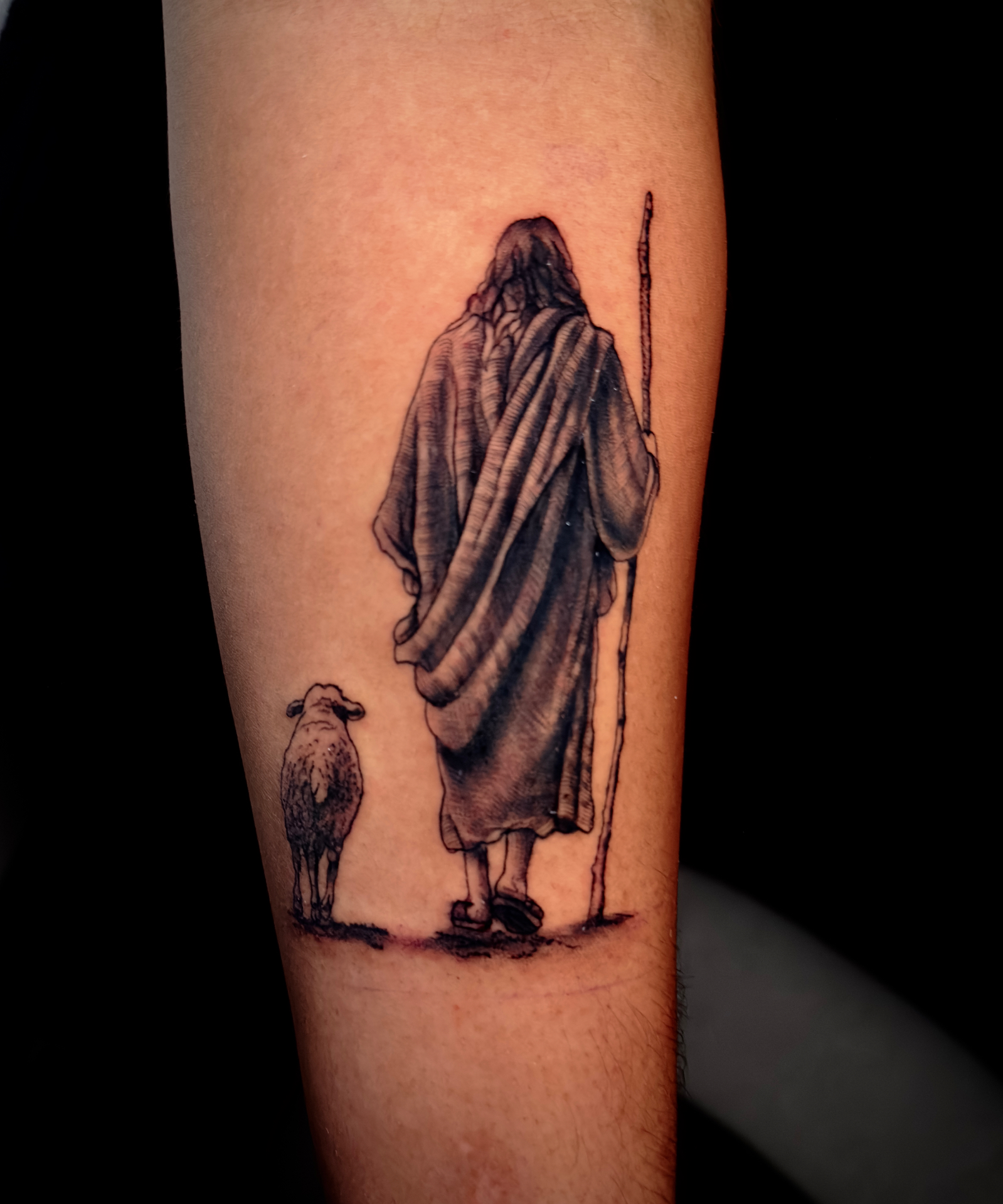 Fine-detail black and grey shepherd and sheep tattoo by Ramón Santiago at R INKS ARTS