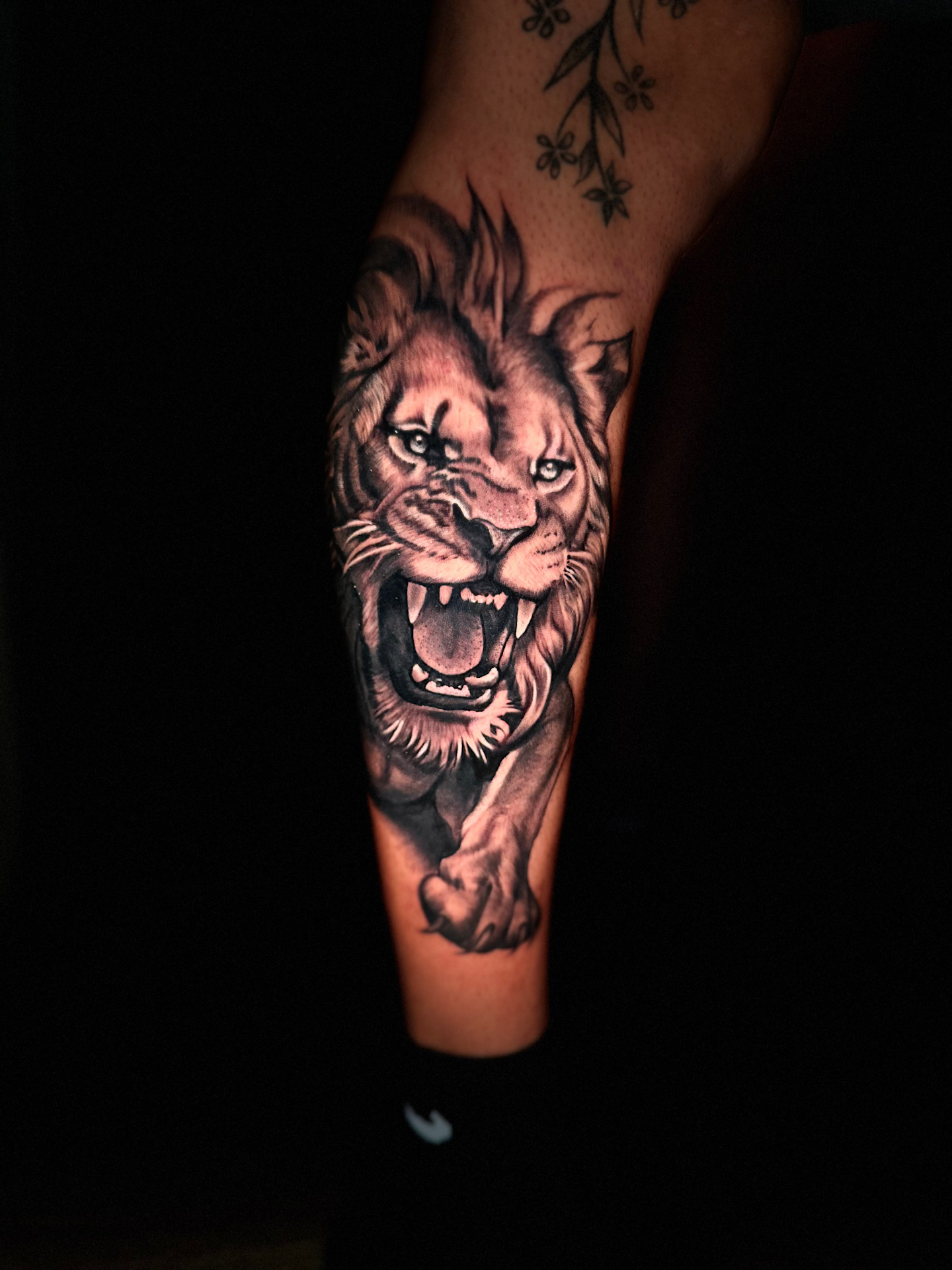 Black and grey roaring lion forearm tattoo by Ramón Santiago at R INKS ARTS